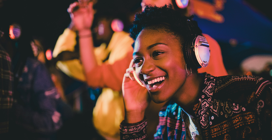 woman smiling wearing headphones at silent disco